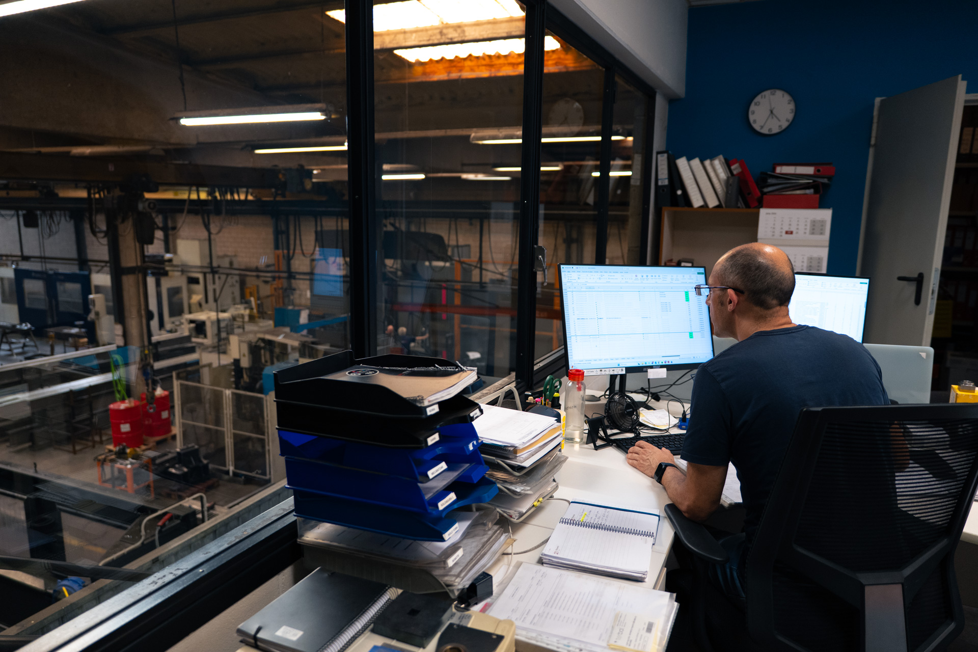 Office work overlooking the workshop